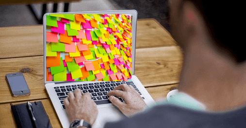 Main image: how to improve website stickiness: Tips for Copywriters (computer with post-it notes on the screen