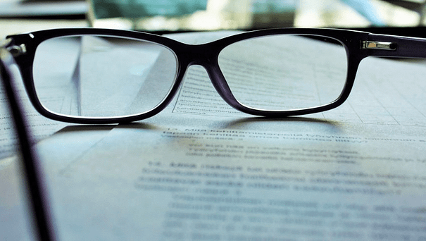 Related Image: an business person's glasses on a serious-looking document